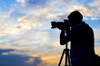 Silhouette of a photographer taking a picture in sunset