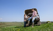 Farmer and daughter with dogs on tailgate of truck in field