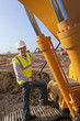 Portrait of construction worker standing on construction machinery