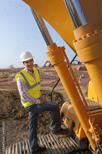 Photo: Portrait of construction worker standing on construction machinery Portrait of construction worker standing on construction machinery