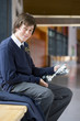 Foto: Portrait of smiling male student in school uniform holding trophy in school corridor Portrait of smiling male student in school uniform holding trophy in school corridor