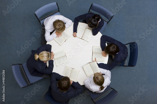 Photo: Students reading at round table in school library Students reading at round table in school library