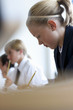 Photo: Female student in school uniform taking notes Female student in school uniform taking notes