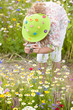 Girl bending down taking photographs of wildflowers