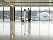 Business people talking together in airport terminal
