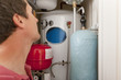 Photo: Plumber looking at central heating boiler Plumber looking at central heating boiler