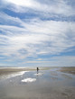 Woman walking in tide pools on beach at low tide