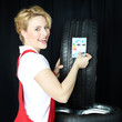 Female car mechanic sticks on a tire label on summer tire