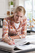 Photo: Young woman circling classified ad in newspaper Young woman circling classified ad in newspaper