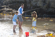 Photo: Father fishing with daughter and son in tide pool Father fishing with daughter and son in tide pool