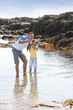 Photo: Father and daughter catching crab with fishing rod in tide pool Father and daughter catching crab with fishing rod in tide pool