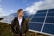 Farmer standing in front of solar panels