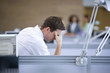 Businessman looking down with head in hands in office