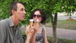 Video: Young, Happy Couple in Park Eating Ice Cream Young, Happy Couple in Park Eating Ice Cream