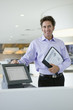 Photo: Portrait of smiling man holding menu in restaurant Portrait of smiling man holding menu in restaurant