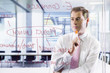 Businessman looking at flow chart on glass window