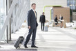 Businessman with suitcase arriving at airport