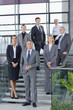 Portrait of confident business people in suits standing on steps