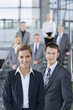 Portrait of confident business people in suits standing on steps