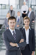 Portrait of confident business people in suits standing on steps