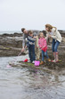 Family fishing on rocks with nets