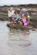 Family fishing on rocks with nets