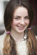 Close up portrait of smiling girl with braces and pigtails