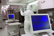 Photo: Engineer in clean suit working at machinery in silicon wafer manufacturing laboratory Engineer in clean suit working at machinery in silicon wafer manufacturing laboratory