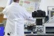 Photo: Engineer examining circuit diagram in laboratory with telescope in foreground Engineer examining circuit diagram in laboratory with telescope in foreground