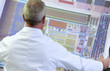 Photo: Engineer examining circuit diagram in laboratory Engineer examining circuit diagram in laboratory