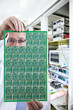 Photo: Engineer examining printed circuit board in laboratory Engineer examining printed circuit board in laboratory