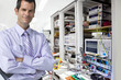 Portrait of confident, businessman in silicon wafer manufacturing laboratory