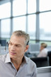 Smiling businessman wearing headset in office