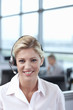 Portrait of smiling businesswoman wearing headset in office