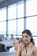Brunette businesswoman talking into headset in office
