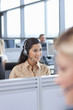 Brunette businesswoman wearing headset in office
