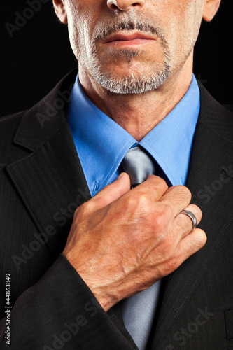 Photo: Businessman adjusting his tie Businessman adjusting his tie