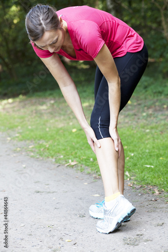 Photo: woman having cramp while running woman having cramp while running