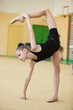 young gymnast stretching and training