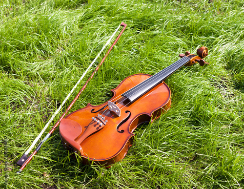 Photo: Violin on a green grass. Violin on a green grass.
