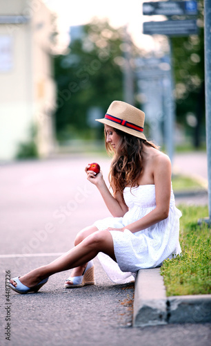 Photo: Young woman with fresh peach in her hand Young woman with fresh peach in her hand