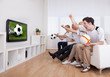 Jubilant Family Watching Telev...