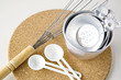 measuring cups with spoon and whisk