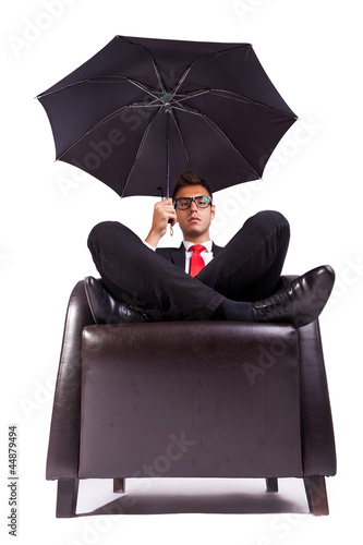 Foto: man sitting in comfortable armchair with umbrella man sitting in comfortable armchair with umbrella