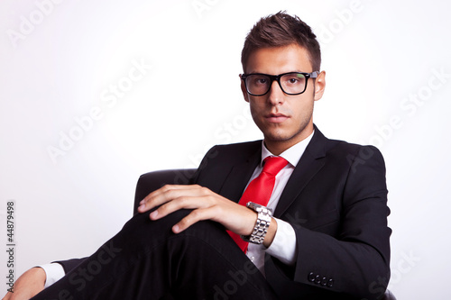 Photo: serious young business man seated serious young business man seated