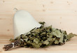 Bath broom of oak and hat on wooden background