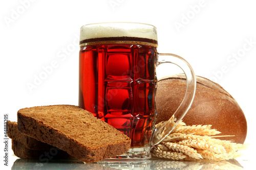 Photo: tankard of kvass and rye breads with ears, isolated on white tankard of kvass and rye breads with ears, isolated on white