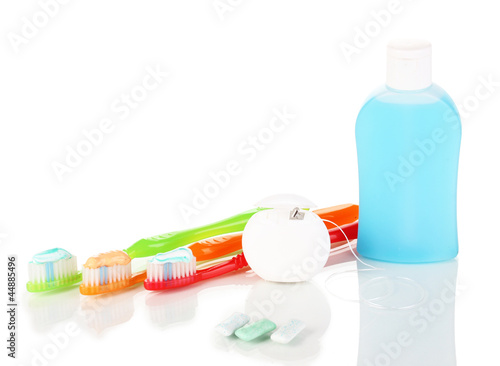 Photo: Toothbrush, chewing gum and dental floss isolated on white Toothbrush, chewing gum and dental floss isolated on white