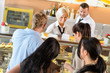 Foto: People buying cakes at cafeteria queue desserts People buying cakes at cafeteria queue desserts