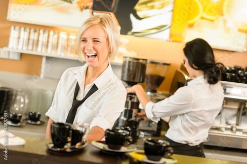 Photo: Waitress serving coffee cups making espresso woman Waitress serving coffee cups making espresso woman